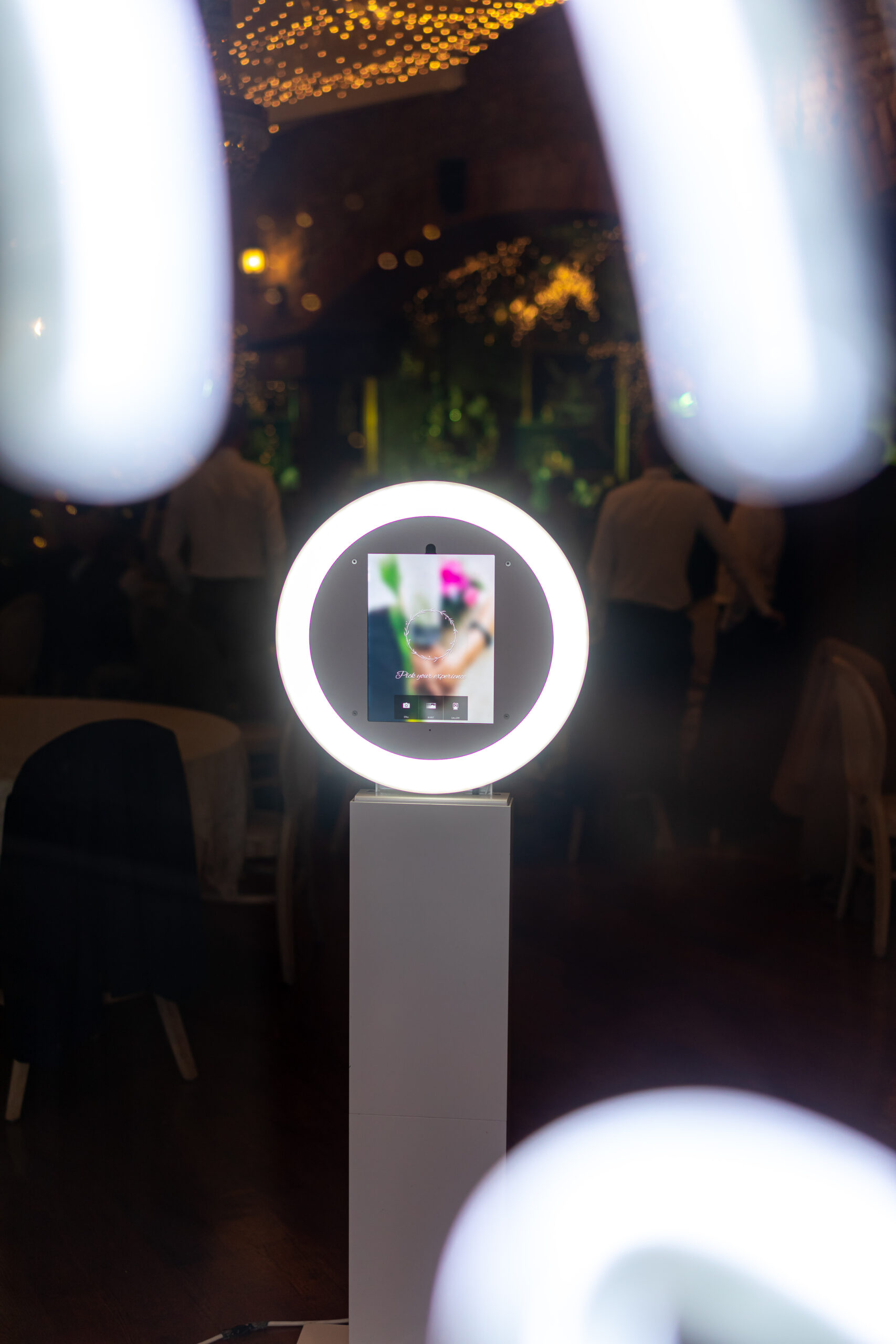 360 photo booth setup at a wedding event with guests enjoying entertainment